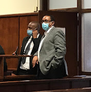 Suspended eThekwini city manager Sipho Nzuza, right, with his instructing attorney at the Durban specialised commercial crimes court on Monday.