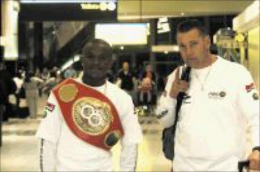 Malcolm Klassen from Toekomsrus, Gauteng, South Africa an IBF Super featherweight champion will defend his title against American Robert Joseph Guerrero at the Toyota Center, Houston, Texas, United States on the 02/08/2009. He was accompanied by trainer Gert Strydom when they left OR Tambo International Airport for Houston, Texas, United States. Pic: Bafana Mahlangu. 15/08/2009. © Sowetan.