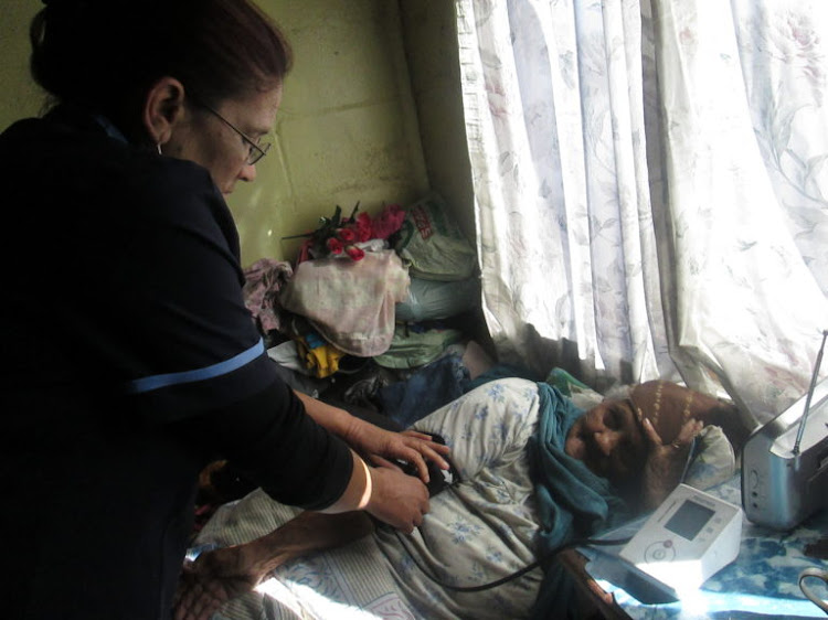 A nurse attends to a patient at Tygerberg Hospice.