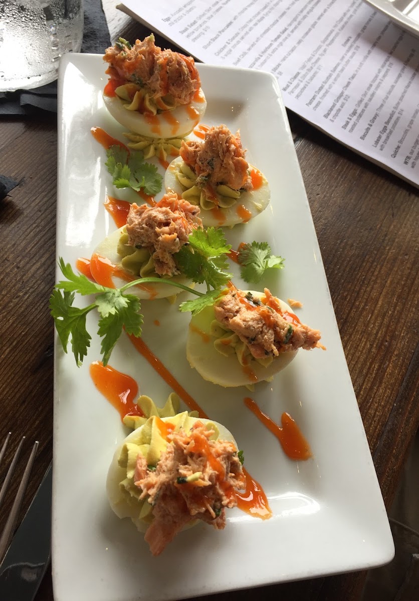 Avocado deviled eggs topped with salmon