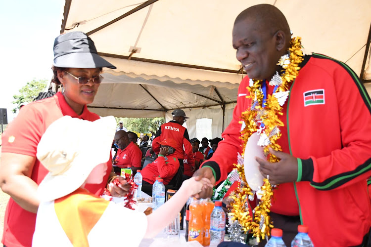 Head of directorate, Field Coordination and Co-curricular Activities, Nelson Sifuna greets a learner during the official opening of Primary and Secondary Schools Special Needs Games at Nakuru Boys High School.