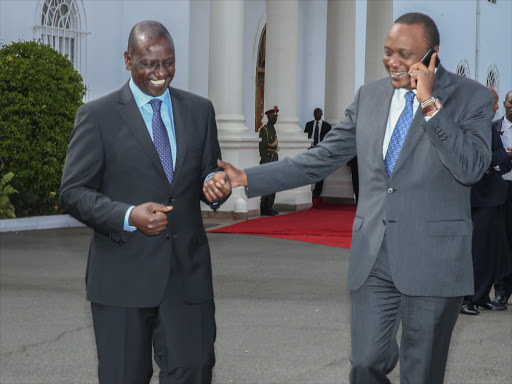 President Uhuru Kenyatta shares a light moment with Deputy President William Ruto at at State House, Nairobi, after ICC chief Prosecutor Fatou Bensouda dropped charges against him, December 2014. Photo/PSCU