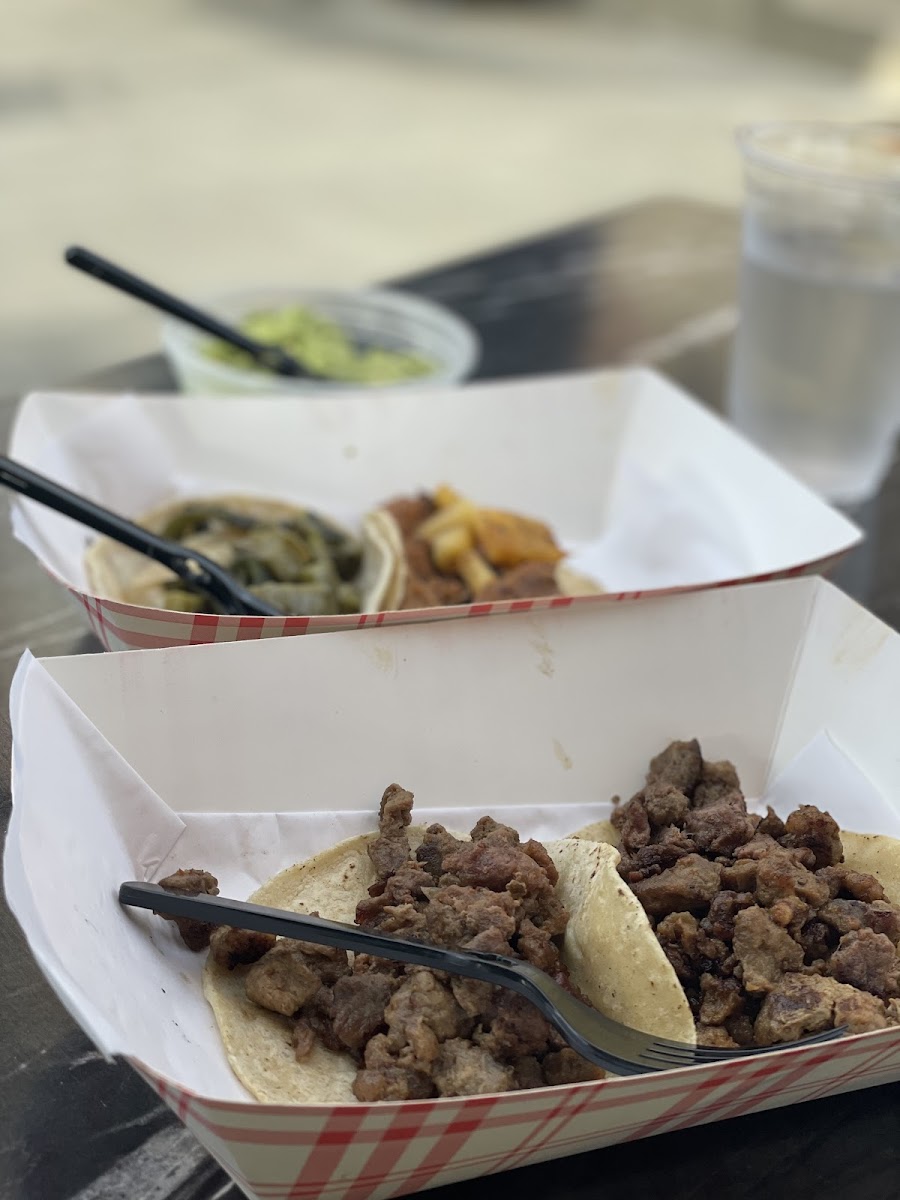 Front: bistec taco, middle: nopales and poblano taco, taco al pastor, back: guacamole