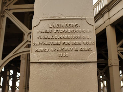 The plaque reads: Engineers. Robert Stephenson C.E. Thomas E. Harrison C.E. Contractors for iron work Hawks, Crawshay & Sons. 1850 A second plaque was added recently documenting the major...