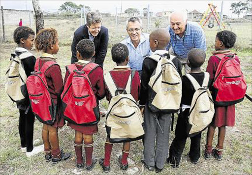 GOOD CAUSE: The Carmel Curlewis Trust, facilitated by the Gately Rotary Club, donated stationary packs for to primary school learnerspupils in Newlands yesterday. From left: Stephen Keet, Eugene McNamara and Terry Beckermann from the Gately Rotary Club with some of the children that who received packs