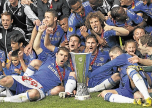 COMING GOOD: Chelsea players and officials celebrate with the trophy after defeating Benfica in their Europa League final. Chelsea will host Everton at the weekend Photo: REUTERS