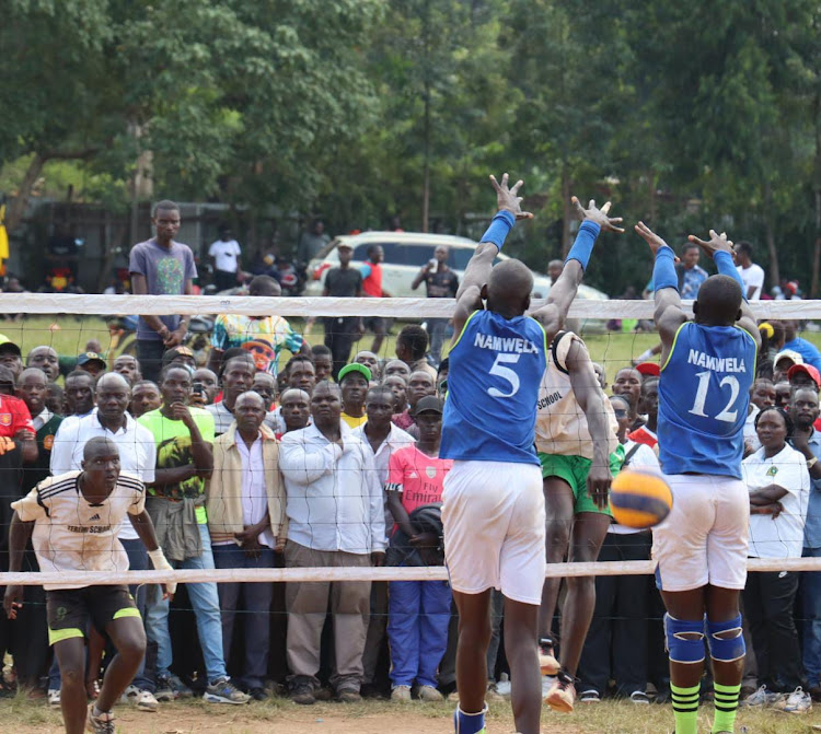 Namwela Boys (in blue) in action against Teremi Boys during the Bungoma County volleyball final