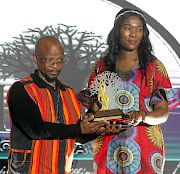 Sello Galane  receives his Lifetime Achievement award from MEC  Thandi Moraka. 