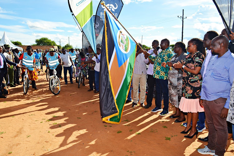 Kitui governor, Julius Malombe, officiates by flagging off CHPs on bicycles during the Friday ceremony to issue bicycles to Community Health Promoters in Mwingi North Sub County.