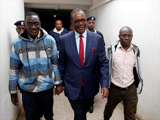 Former governor Evans Kidero and Maurice Okere walking to court room on August 8./REUTERS