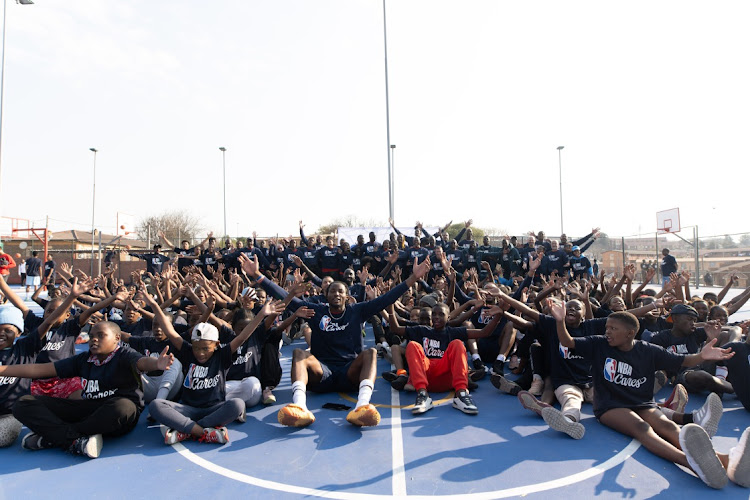 Bam Adebayo is surrounded by excited youngsters in Alex after the NBA unveiled newly renovated basketball courts during their BWB Africa event.