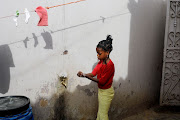 A girl washes her hands at the entrance of her parents' house in Pikine, on the outskirts of Dakar, Senegal, on March 9 2020. 