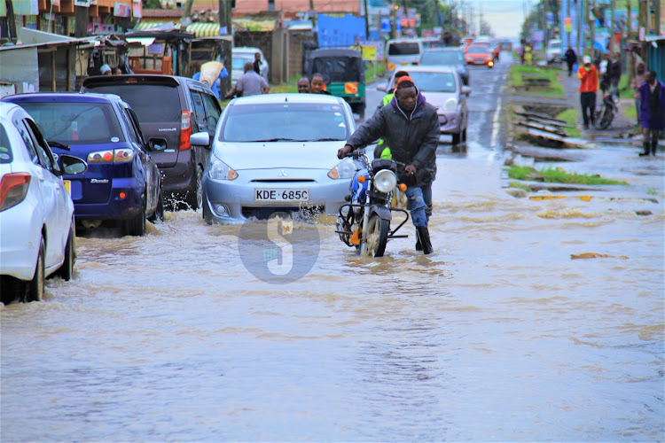 A boda boda rider along the flooded Syokimau-Katani road in Machakos County on Sunday, April 21, 2024.