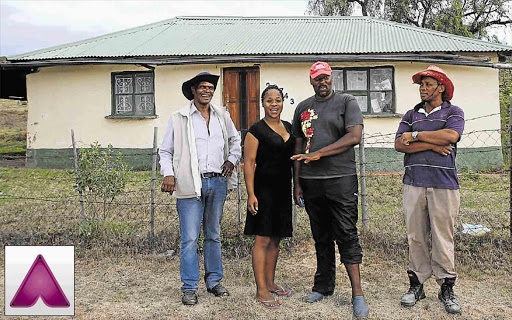 REDUCING CRIME:The team, from left, Mxolisi Jonguhlanga, Belinda Madliwa, Gugulethu Siwendu and Community Police Forum chairman Nyaniso Sigom in front of a house, formerly a brothel, that used under-age girls, before the community shut it down See page 3 for details on how to view video footage from this story Picture: MALIBONGWE DAYIMANI