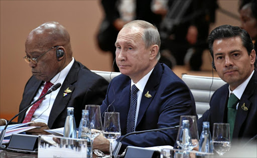L-R) South Africa's President Jacob Zuma, Russia's President Vladimir Putin and Mexico's President Enrique Pena Nieto sit the start of the first working session of the G20 meeting in Hamburg, Germany, July 7, 2017. REUTERS/John MACDOUGALL,POOL