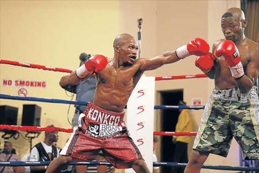 ON RECEIVING END: Simpiwe Konkco, left, going after Nkosinathi Joyi at the Orient Theatre on Sunday. Joyi’s camp has blamed his lack of action for his loss to Konkco Picture: MARK ANDREWS
