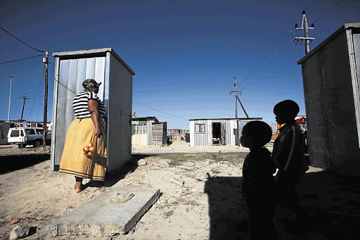 Nothemba Mpemyama, of Makhaza informal settlement, Cape Town, at a toilet enclosure. File photo