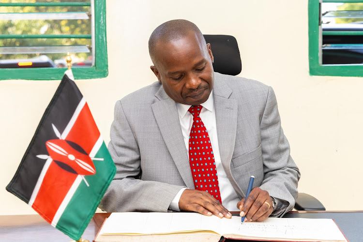 Interior CS Kithure Kindiki singining a visitors book in Kwale on March 27, 2024.