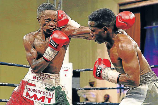 IN THE SPOTLIGHT: Siphamandla Baleni, right, lands a stunning right. He and Athi Dumezweni were feted in Mthatha last week Picture: ALAN EASON