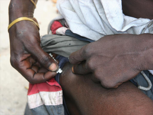A drug addict injects himself at Makadara Grounds, Mombasa, on No- vember 23 last year. Many people who inject drugs are HIV positive.
