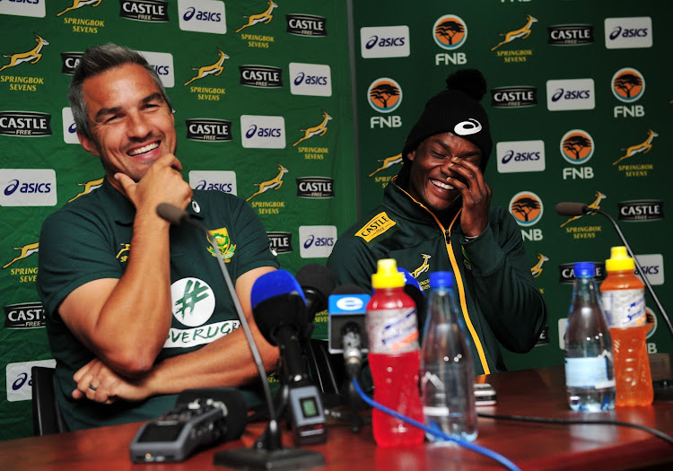 South Africa Sevens coach Neil Powell and Seabelo Senatla have a laugh during the South Africa Sevens team arrivals at Cape Town International Airport on June 12 2018.