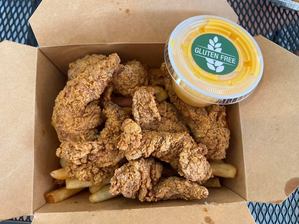 Gluten-free chicken fingers and fries with a side of GF whiz