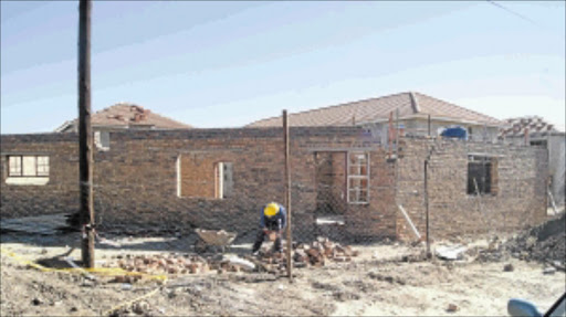 RAW DEAL: One of the construction workers at work at Seshego Hostel in Limpopo. The workers say contractor Steve Bosch has not paid them since May and often fails to pay them their monthly salaries. PHOTO: MOYAHABO MABEBA