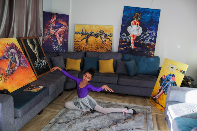 Maya Harb takes part in ballet dancing at her home in Gaza City.