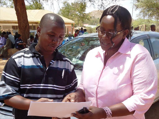 The Kyuso Knut branch treasurer Peter Muthengi and executive secretary Agnes Kambua during a function at Kyuso boys secondary school in the past. Photo by Musembi Nzengu