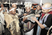 WELCOME TO THE CLUB: Xhosa King Mpendulo Sigcawu, left,  ties Chief Velile Ndevu's leaders    shoulder wear to mark his annointment as the head of  Imiganu Traditional Council during a   ceremony held  at Mkhathazo Great Place near Elliotdale, Eastern Cape. Helping the king are chiefs  Ngangomhlaba Matanzima and  Phathekile Holomisa. The writer says traditional leaders deserve the recognition they are getting.     Photo:  Lulamile Feni