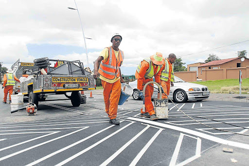 Construction workers busy making speed bumps Picture: SIBONGILE NGALWA