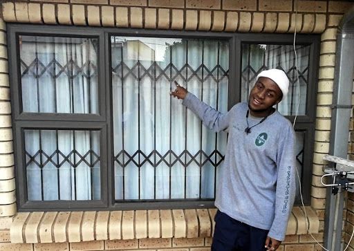 Gloria Sogoni's son Siyamthanda is thrilled that the house now has burglar proofing on the doors and windows. / SUPPLIED