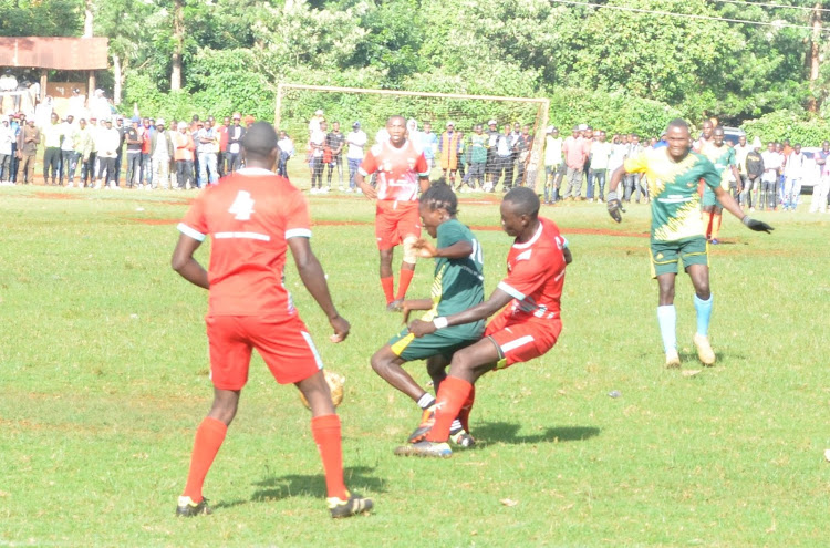 Kairo FC and Nyangiti FC players battle it out during the Edwin Mugo Cup finals at Rurii stadium.