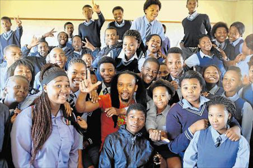 LOYAL SON: Clinical psychologist Mthetho Tshemese is surrounded by Grade 11 pupils at his former school, Sinikiwe High, in Mdantsane’s NU7