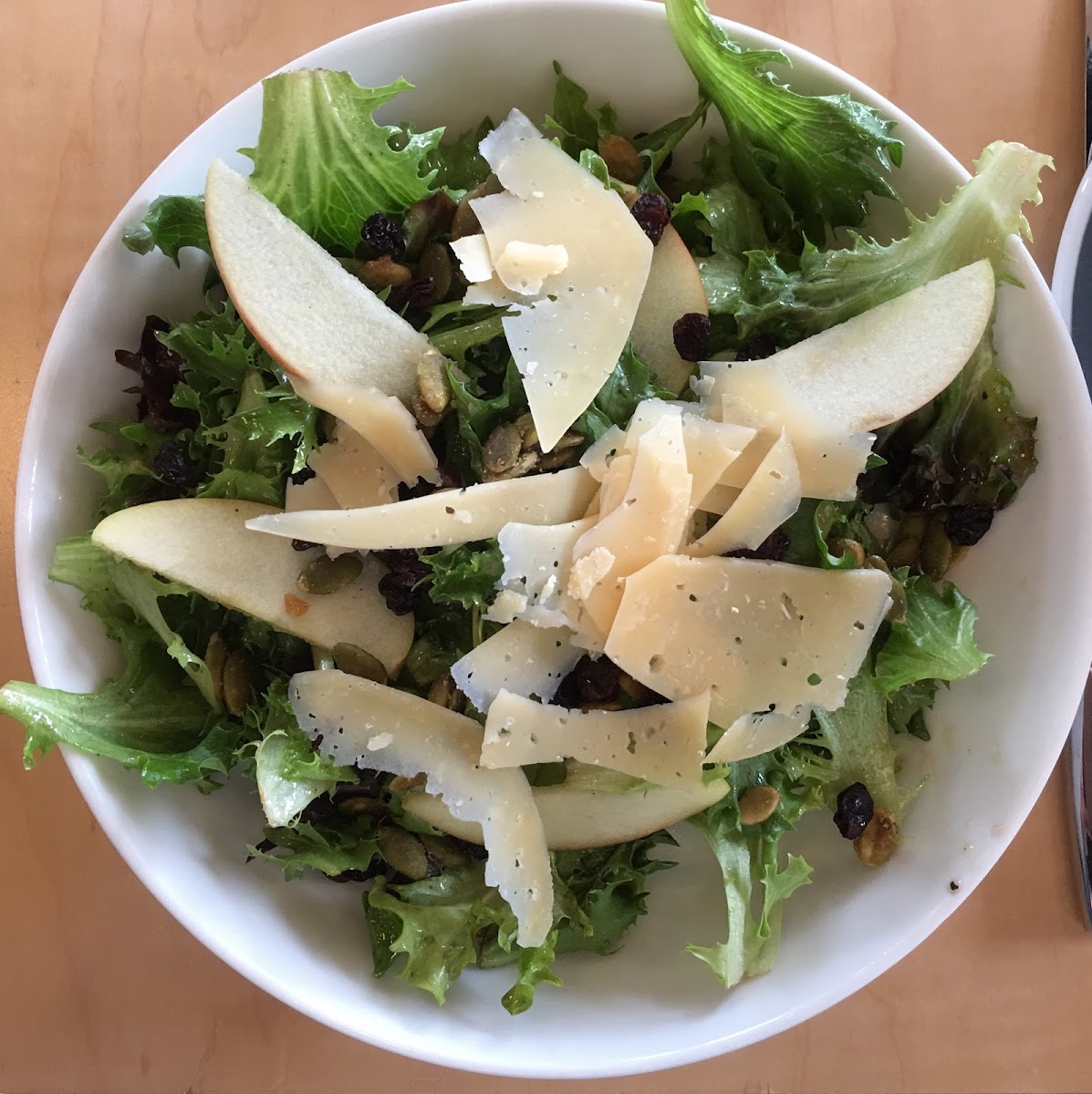 House Salad with Candied Pepitas, Currants and sliced Parmesan.