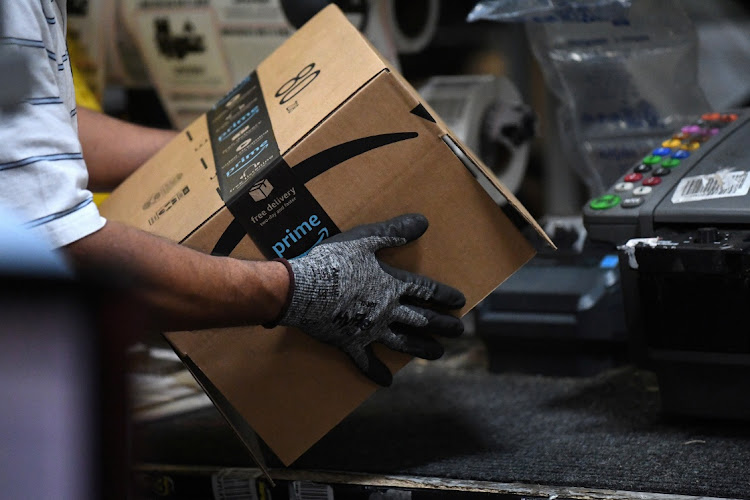 A worker assembles a box for delivery at the Amazon fulfilment centre in Baltimore, Maryland, the US. Picture: REUTERS/CLODAGH KILCOYNE