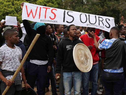 Students chant slogans during clashes with the South African police at Johannesburg's University of the Witwatersrand, South Africa, October 4, 2016. /REUTERS