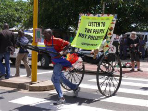 A smaller version of the poster Greenpeace activists tried to put up on a hotel in Durban for thier COP17 protest.