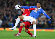 Youssef Chermiti of Everton battles for possession with Alexis MacAllister of Liverpool during their Premier League at Goodison Park on 24 April 2024 in Liverpool, England. 
