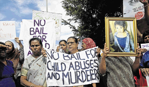OUTRAGED: Chatsworth residents outside the magistrate's court where two women appeared on charges of abusing and killing three-year-old Jamie Faith Naidoo