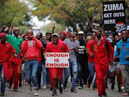 Protesters hold placards as they march in South Africa's capital to protest against President Jacob Zuma in Pretoria, South Africa, April 12 ,2017. /REUTERS