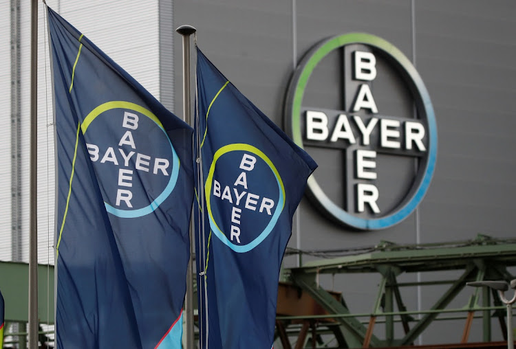 The logo and flags of Bayer AG are pictured outside a plant of the German pharmaceutical and chemical maker in Wuppertal, Germany. Picture: WOLFGANG RATTAY/REUTERS