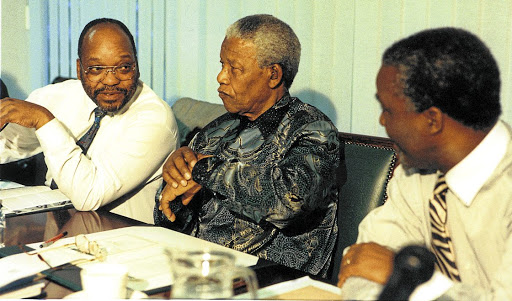 Nelson Mandela is flanked by Jacob Zuma and Thabo Mbeki. The writer says Zuma played a significant role during the multiparty negotiations for a new dispensation.