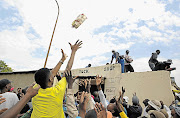 ANARCHY: Bread is tossed from a looted shop in Meadowlands, Soweto