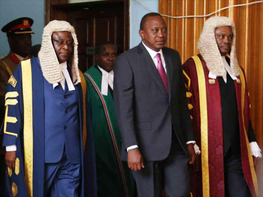 President Uhuru Kenyatta is welcomed by Senate Speaker Ekwee Ethuro and National Assembly'sJustin Muturi before addressing a joint parliamentary sitting on the state of the nation, March 15, 2017. /HEZRO NJOROGE