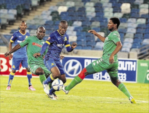 CONGESTION: Mamelodi Sundowns' Asavela Mbekile tightly marked by AmaZulu's Thabiso Dlamini and Bongani Ndulula during their Absa Premiership match at Moses Mabhida last night. Downs won 1-0. PHOTO: THULI DLAMINI