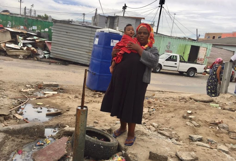 West Beach informal settlement community leader, Xoliswa Mbetheni says at night residents have to relieve themselves in plastic bags and buckets, which they empty in stormwater drains. They then rinse their buckets at a communal standpipe the next day.