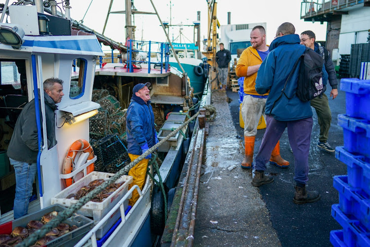 Crews from different fishing boats unload their catch in Bridlington, UK, on October 15 2020. The U.K.'s exit from the EU has sparked a battle over fishing in waters British and EU trawlers have shared for four decades. Picture: BLOOMBERG/IAN FORSYTH
