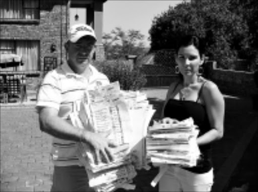 LOST AND FOUND: Jakkie Geldenhuys and his wife, Hanline, with about 400 ballot papers they found along the R40 road between White River and Nelspruit at the weekend. 20/04/2009. Pic. Alfred Moselakgomo. © Sowetan.
