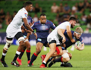 Matthew Philip of the Rebels gets tackled during the round six Super Rugby match between the Melbourne Rebels and the Sharks at AAMI Park on March 23, 2018 in Melbourne, Australia. 
